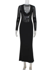 Floor-length slim fit black formal dress with sheer sleeves on a mannequin against a white background