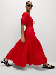 A close-up shot of the puff sleeve and the lace-up detail on the dress.