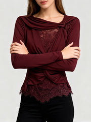 Close-up of lace trim and fold detail on v-neck draped top