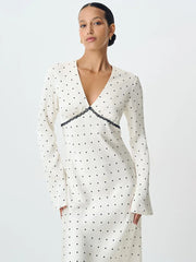 A full-length shot of a long-sleeve V-neck party dress, highlighting its bodycon silhouette.