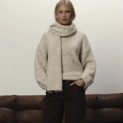 Close-up of the sweater neckline showing the integrated scarf drape and soft knit texture.