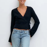 A woman modeling a V-neck side tie cardigan.