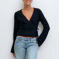 A woman modeling a V-neck side tie cardigan.