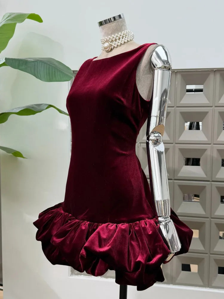 Detail of the cloud-style bubble hem showing gathered volume on a velvet mini party dress photographed against a light background.