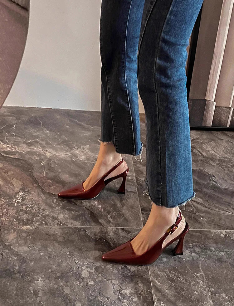 Stylish brown sandals paired with cropped jeans indoors