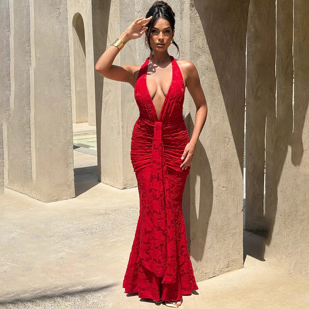 Vibrant red evening halter dress shown with gold accessories