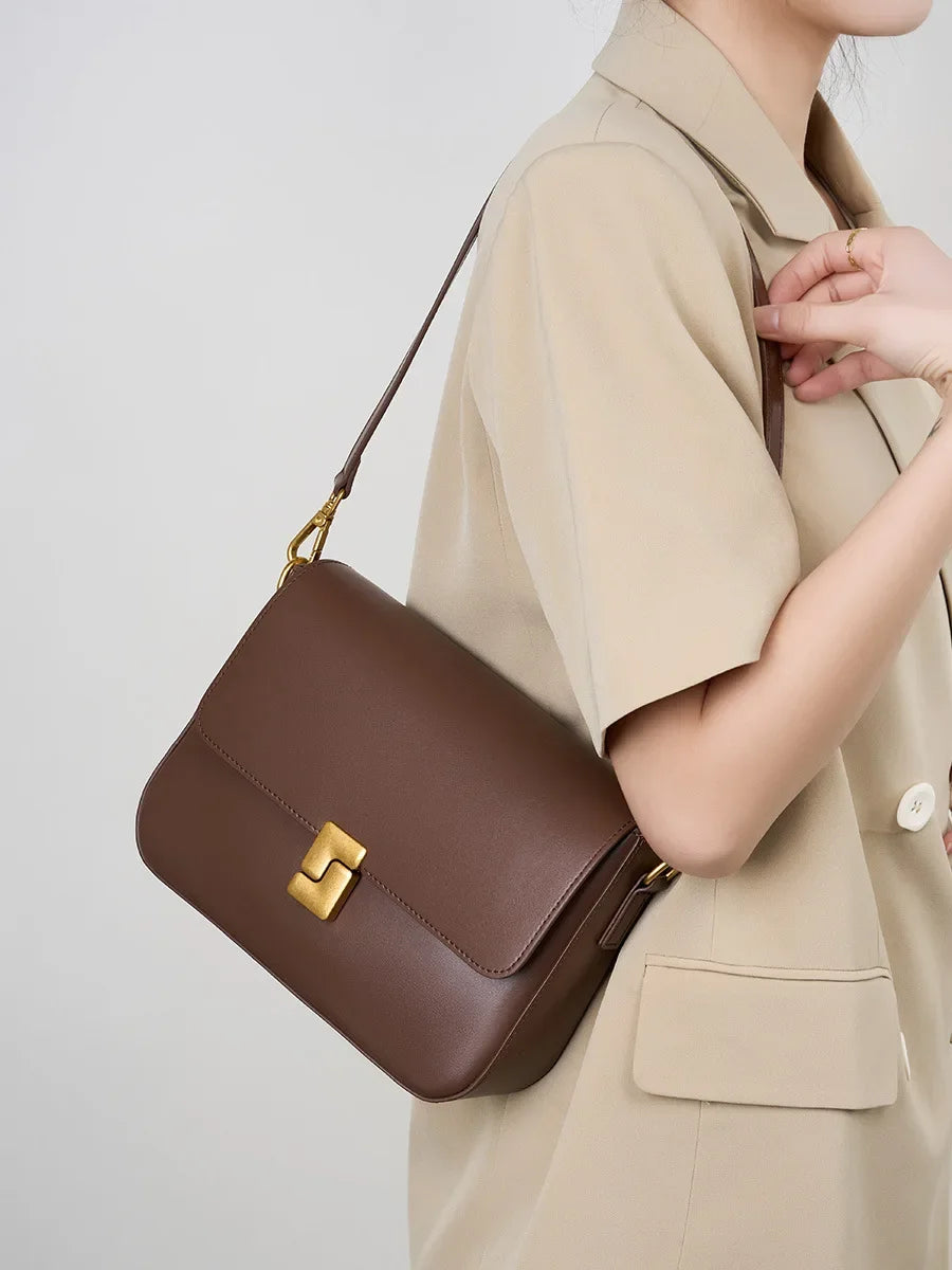 Small leather crossbody bag with flap front and lock hardware