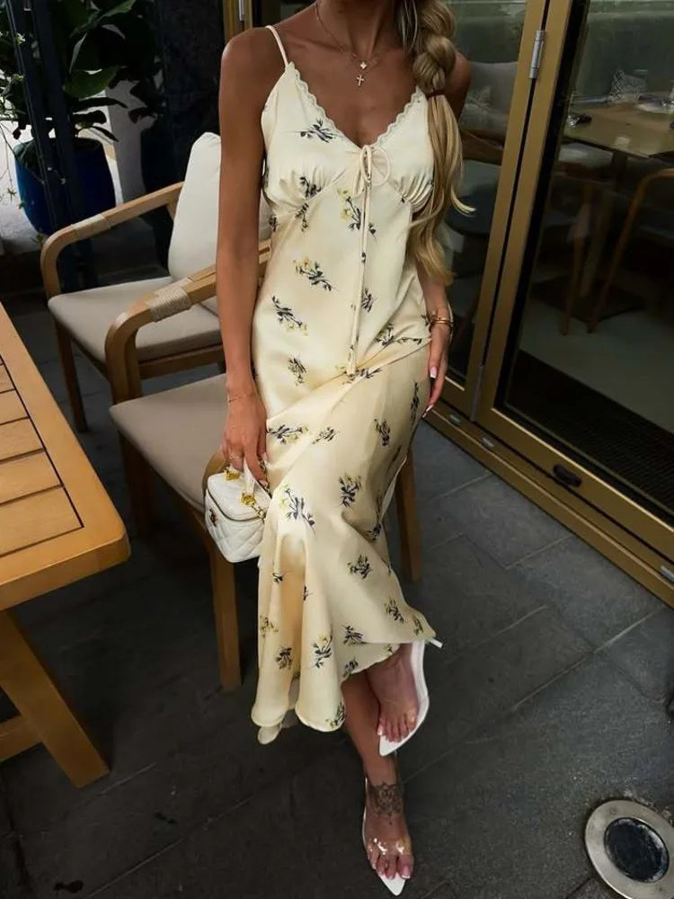 floral satin slip maxi styled with heels and a mini bag outdoors