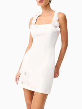 White mini dress with 3D flower straps and slim silhouette