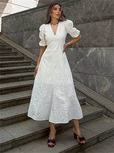 White backless summer dress with puff sleeves and V-neckline