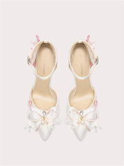 White bow pearl stiletto heels with silk butterfly-knot and floral accents