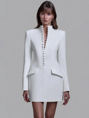White long sleeve blazer mini dress on a model with a clean button-up front and tailored sheath silhouette.