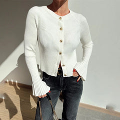 Side view of white cardigan showing flared cuffs and fitted waist
