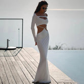 White slash neck cut-out maxi dress on dock by water