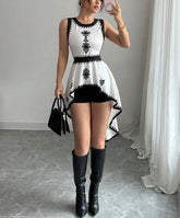 White embroidered high-low tank dress styled with black boots for summer
