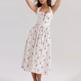 White floral midi dress with lace-up front and square neckline on the model on a light gray background