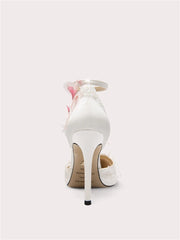 White high-heeled shoe with floral design on a white background