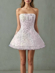 “White strapless mini dress with lace and mesh overlay”