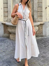 White polka dot belted maxi dress styled for resort city looks