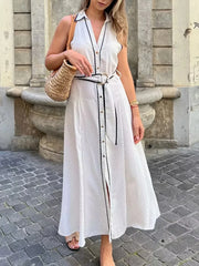White polka dot belted maxi dress styled for resort city looks