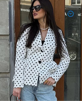 White polka dot short blazer styled as a streetwear jacket over jeans