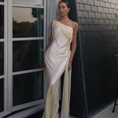 Sleeveless formal dress with asymmetric neckline styled with a small handbag