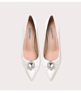 White silk crystal bow pumps styled for brides and formal occasions