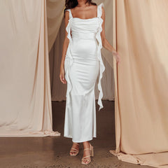 Elegant white ankle-length spaghetti strap dress styled against a white background