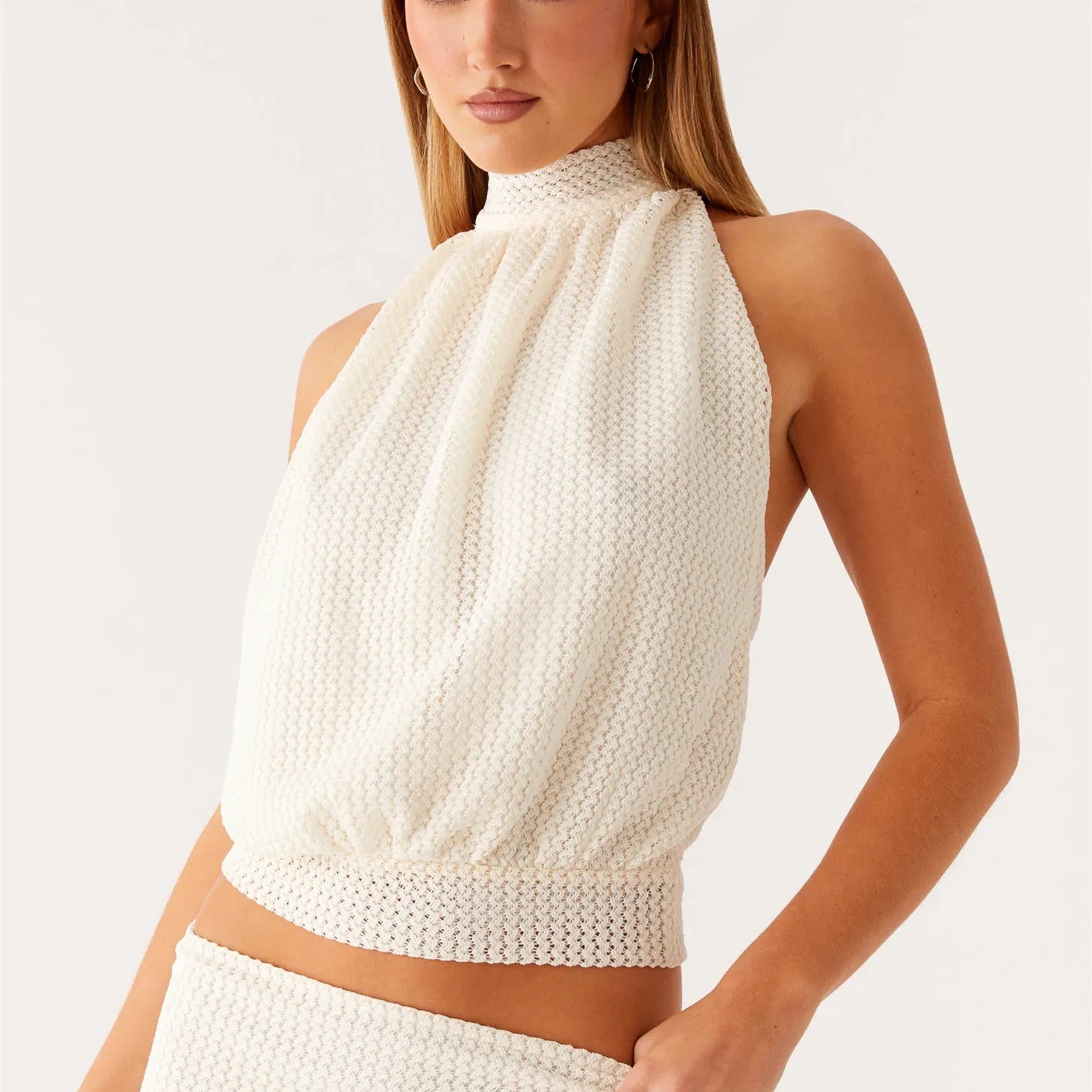White textured halter crop top styled for summer streetwear outfits