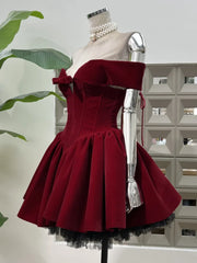Close view of the corset bodice showing the off-shoulder neckline and bow detail on a wine-toned velvet mini dress.