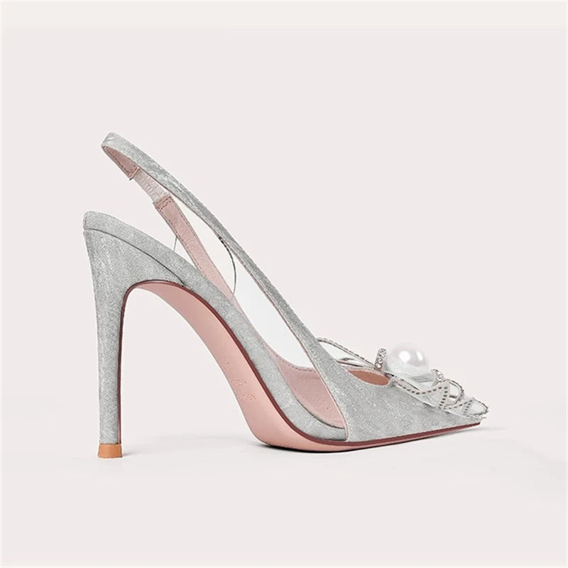 Silver high-heeled shoe with a decorative bow on a light gray background