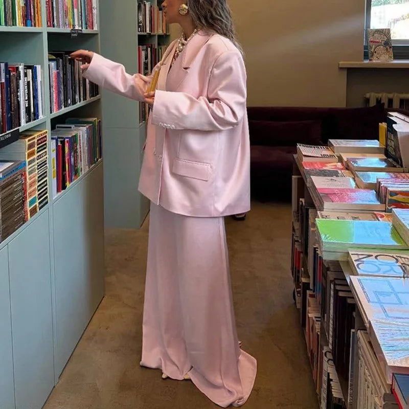 A full-length shot of a women's commuting skirt suit, styled for a professional look.