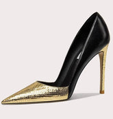 Black and gold high-heeled shoe on a light gray background