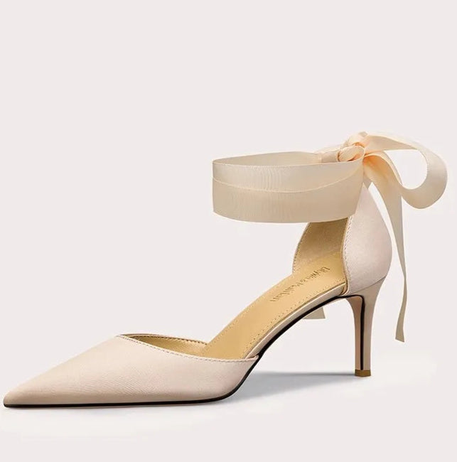 A full-length shot of women's dress shoes, styled with a formal outfit.