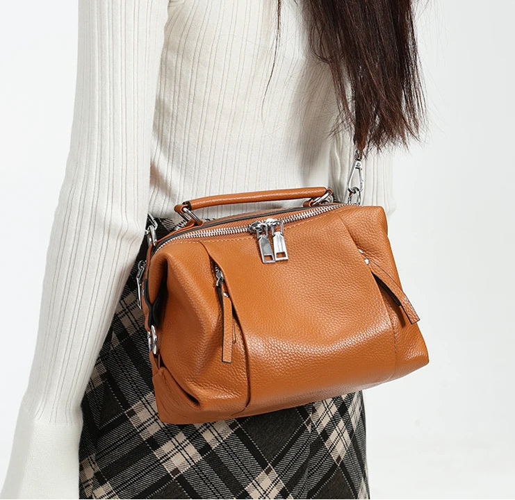 Cowhide leather handbag with cotton lining and multiple interior pockets