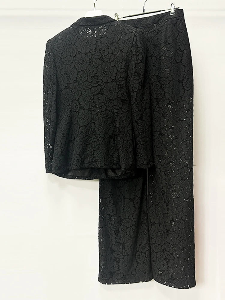 Black lace outfit on a hanger against a white background