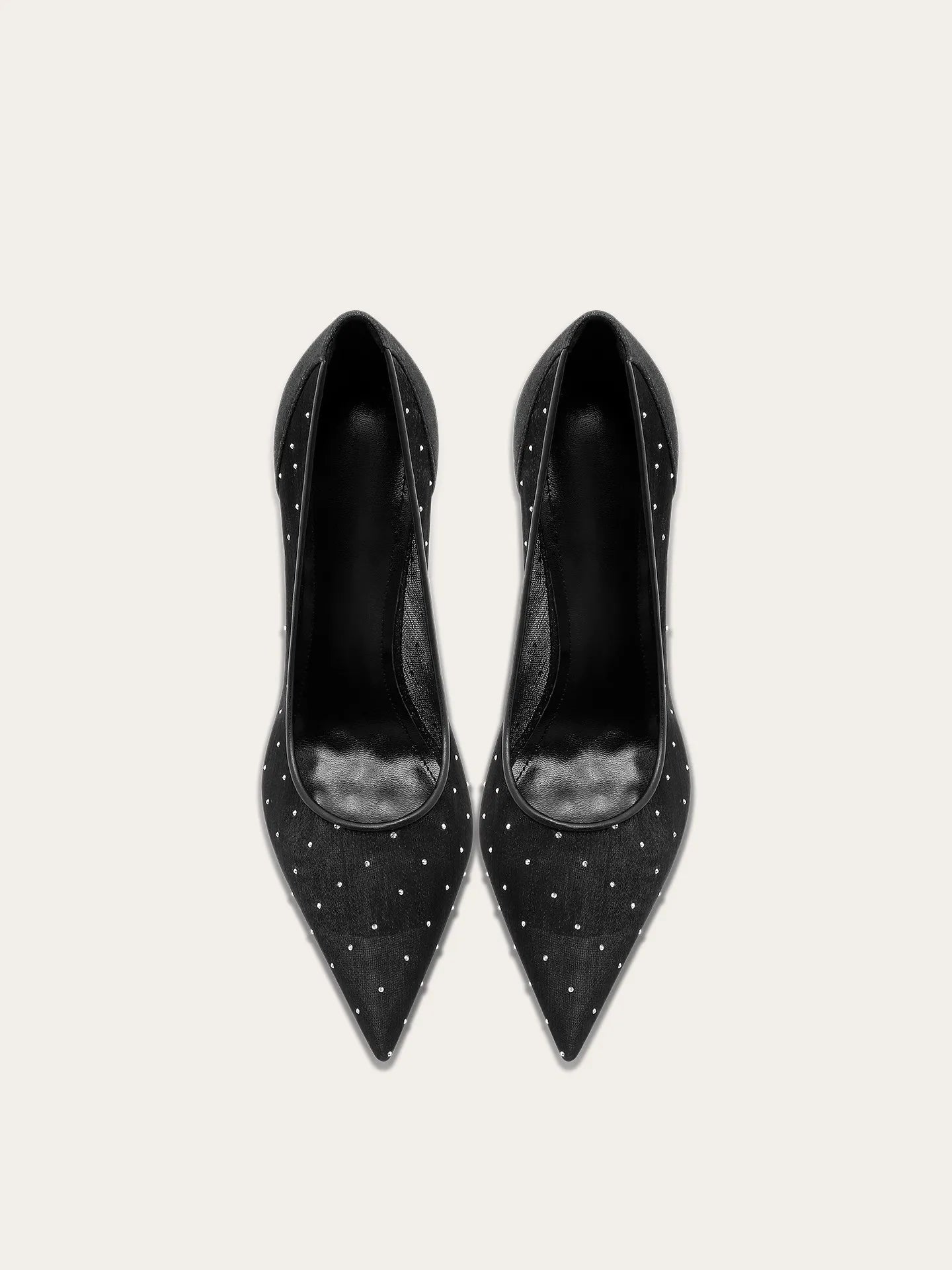 A full-length shot of women's party shoes, styled with a formal outfit.