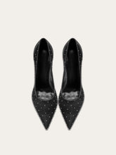 A full-length shot of women's party shoes, styled with a formal outfit.