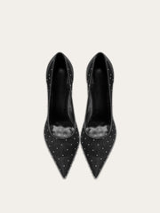 A full-length shot of women's party shoes, styled with a formal outfit.