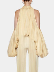 A back view of a woman's slim-fit crop top, highlighting the halter neckline.