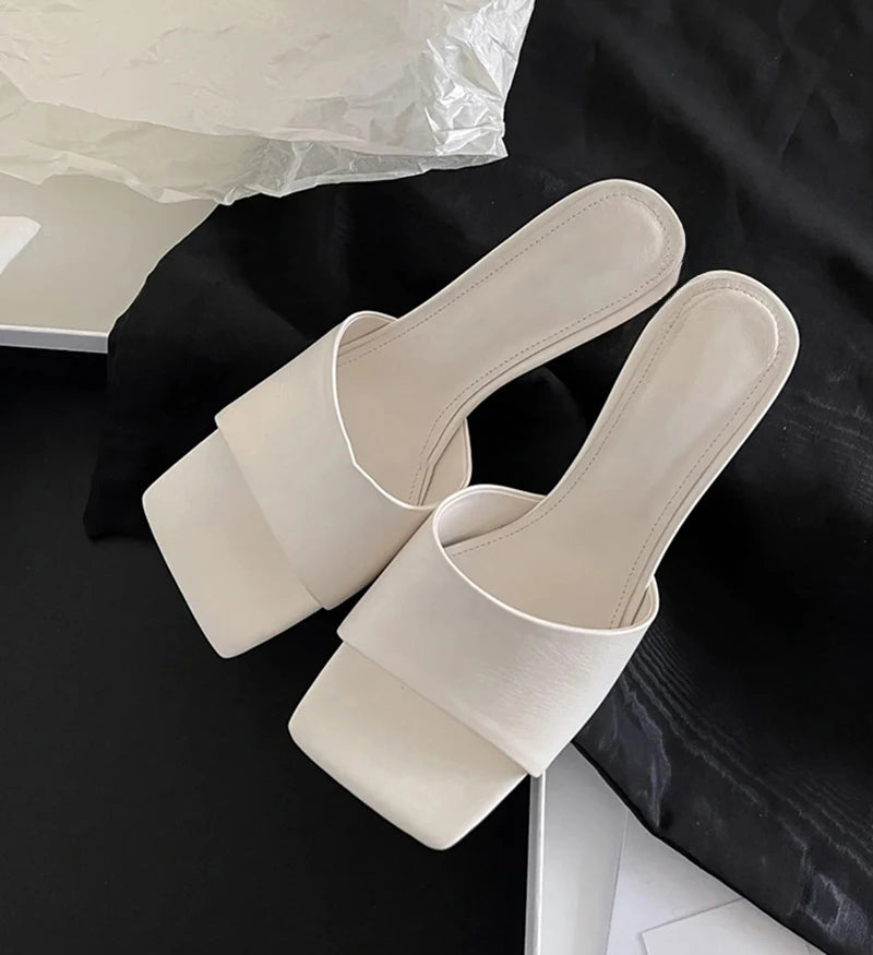 Minimalist women’s white slip-on sandals with wedge heel