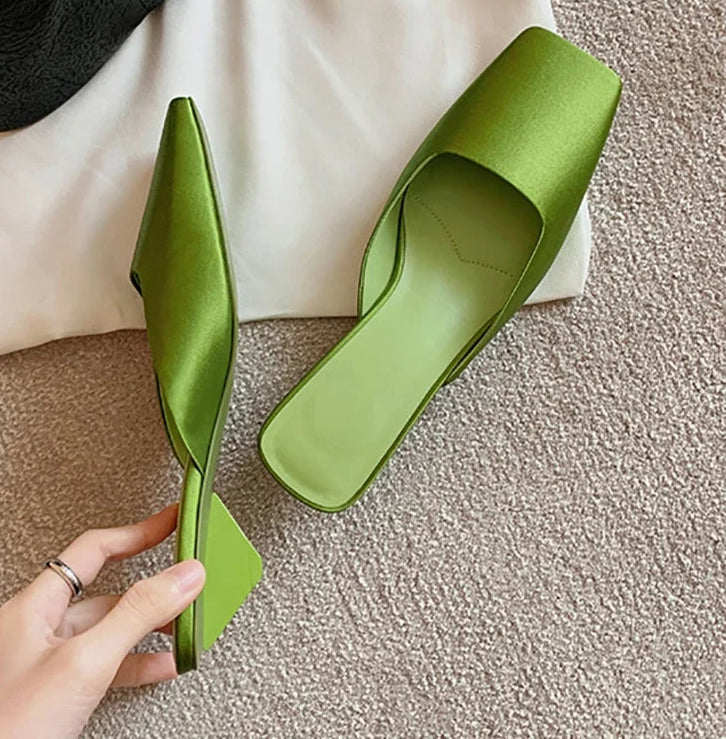 Close-up of shallow toe green slip-on mule sandals