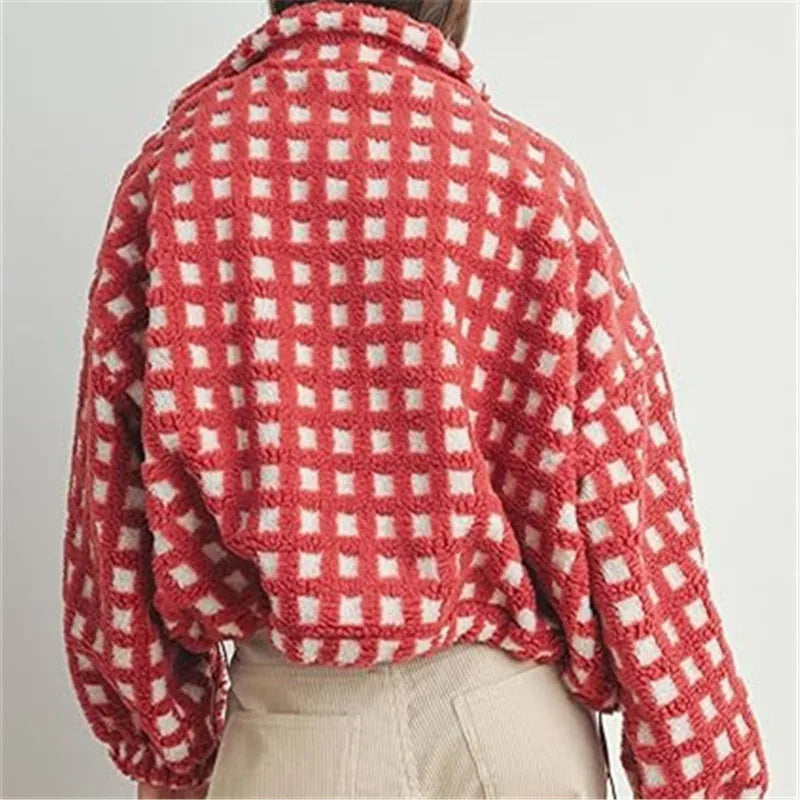 Red and white checkered blanket draped over a person on a plain background