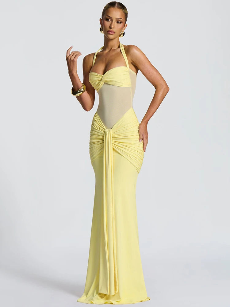 Side view of sleeveless yellow halter dress styled for evening event