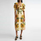 Yellow floral print midi dress styled for summer and travel days