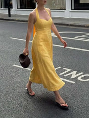 Yellow halter midi dress styled for summer market walks