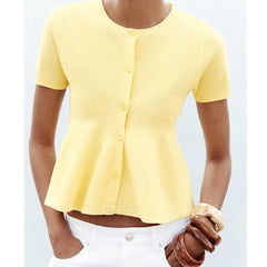 Yellow knit cardigan with short sleeves and flared hem styled for layering