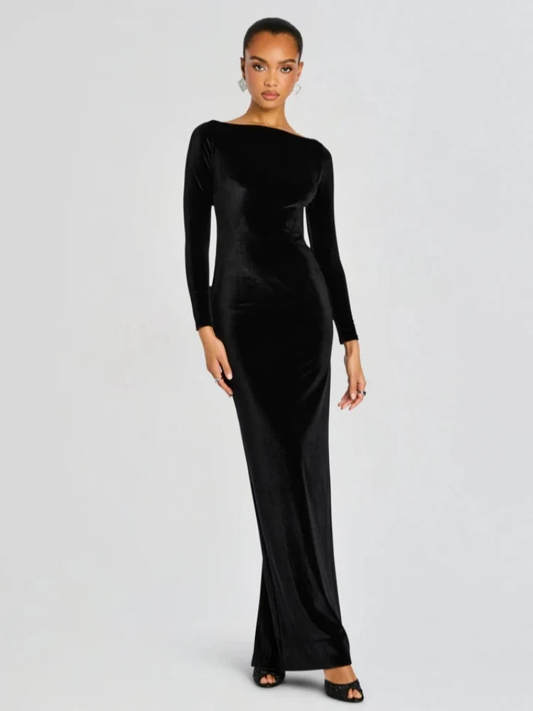 Model wearing a black velvet gown with a boat neckline