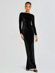 Model wearing a black velvet gown with a boat neckline