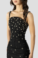 Close-up of floral crystal embellishments on black gown bodice